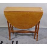 An Edwardian satinwood oval drop flap table, 70cm wide x 63cm high.