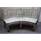 A pair of 20th century slatted teak semi-elliptic garden benches, 180cm wide x 91cm high.