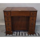 An early 19th century lift top mahogany washstand with eight short drawers, on plinth base,