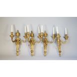 A set of four Louis XVI style ormolu twin light wall appliques, early 20th century,