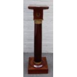 An Empire style gilt metal mounted mahogany pedestal with square top and base on turned column,