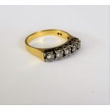 An 18ct gold and diamond set five stone ring, claw set with a row of circular cut diamonds,
