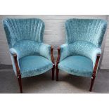 A pair of blue patterned upholstered shell back armchairs, on tapering reeded square supports,