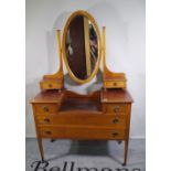 An Edwardian mahogany and inlaid dressing table with oval mirror, 107cm wide x 83cm high.
