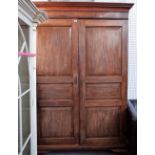 A George III mahogany breakdown wardrobe with a pair of triple panel doors, on bracket feet,