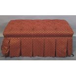 A 20th century rectangular overstuffed footstool with button back upholstery,