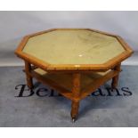 A mid-20th century birds eye maple octagonal coffee table with simulated bamboo border and inset