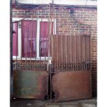 A pair of early 20th century cast iron estate gates with arched tops, 260cm wide x 300cm high, (2).