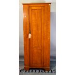 A 20th century pitch pine single door tall cupboard on bracket feet, 75cm wide x 185cm high.