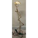 A 20th century abstract copper standard lamp in the form of a standing man with shell shade,