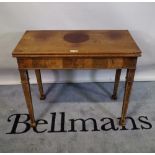 A late George III mahogany foldover tea table on tapering square supports, 86cm wide x 72cm high.