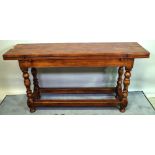 A 17th century style oak extending dining table with hinged rectangular top,