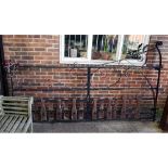 A black painted wrought iron estate gate, with scroll decoration, 293cm wide x 170cm high.
