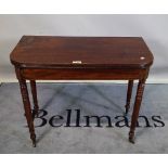 A late Victorian mahogany foldover tea table on ring turned tapering supports,