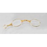 A pair of late Victorian 18ct gold framed lorgnettes, with floral and scroll engraved decoration,