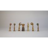 Four late 19th century brass seals, each cast with a claw clutching a hardstone ball,