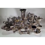 Silver plated wares, including; a vase of tapering form, tea pots, jugs, napkin rings and flatware,