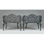 A pair of Coalbrookdale style black painted cast metal concave garden benches,