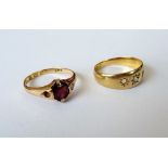 An 18ct gold ring, star gypsy set with a central cushion shaped diamond, (two further gems lacking),