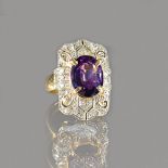 A gold, amethyst and diamond ring, in a curved panel shaped design,