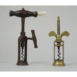 A 19th century brass 'wingnut' corkscrew of twin pillar open barrel form,