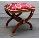 An Empire Revival gilt metal mounted mahogany 'X' frame stool on paw feet, 47cm wide x 53cm high.