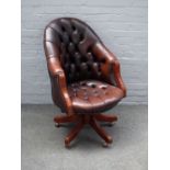 A 20th century studded brown leather upholstered tub back swivel office chair, on five point base,