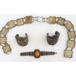An Asian waist belt, the panel shaped links decorated with character motifs,