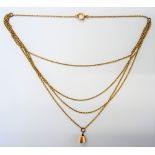 A gold necklace, the front in a four row graduated oval link design, detailed 15,