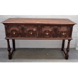 A Charles II style oak dresser base with a pair of geometric drawers, on turned supports,