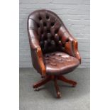 A 20th century studded brown leather upholstered tub back swivel office chair, on five point base,