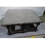 An ebonised square coffee table with marble inset top on turned supports, 103cm wide x 48cm high.
