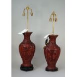 A pair of modern Chinese Cinnabar lacquer vase table lamps each carved with Asian figures against a