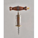 A 19th century corkscrew with turned rosewood handle and brush,