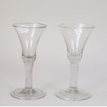 Two plain stemmed glass wine glasses, each with a bell bowl and folded foot, 17.75cm. high, (2).