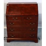 A George III mahogany bureau with fitted interior over two short and three long graduated drawers,
