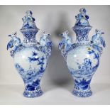 A pair of 20th century Dutch Delft blue and white two handled baluster vases and covers,