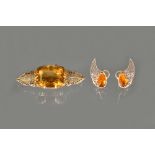A citrine single stone brooch, claw set with a large mixed cut cushion shaped citrine,