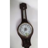 An early 20th century oak aneroid wall barometer, 69cm high.