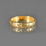 A gold motto or betrothal ring, detailed within the band 'Not the value, but my loue',