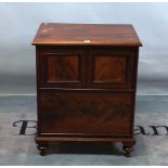 A Regency mahogany commode formed as a side cabinet on tapering supports.