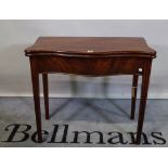 An 18th century mahogany serpentine tea table on square supports, 84cm wide x 73cm high.