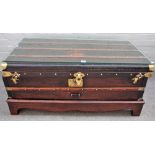 A leather and brass bound steamer trunk/ coffee table, on later stand, 110cm wide x 52cm high.