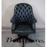 A 20th century Chesterfield style office chair with faux blue leather button back upholstery.