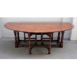 A 17th century style oak wake table, the oval top on baluster supports, 229cm wide x 75cm high.