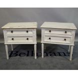 A pair of Louis XVI style white painted two drawer bedside chests on fluted tapering supports,