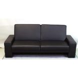 A 20th century faux black leather sofa bed, 193cm wide.