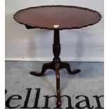 A George III mahogany tripod table, the dished top on three downswept supports,