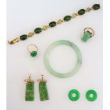 A pair of carved jade pendant earrings, each with a tapered drop, carved and pierced with fruit,