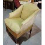 A 20th century framed upholstered armchair with gold upholstery and tapering supports,
